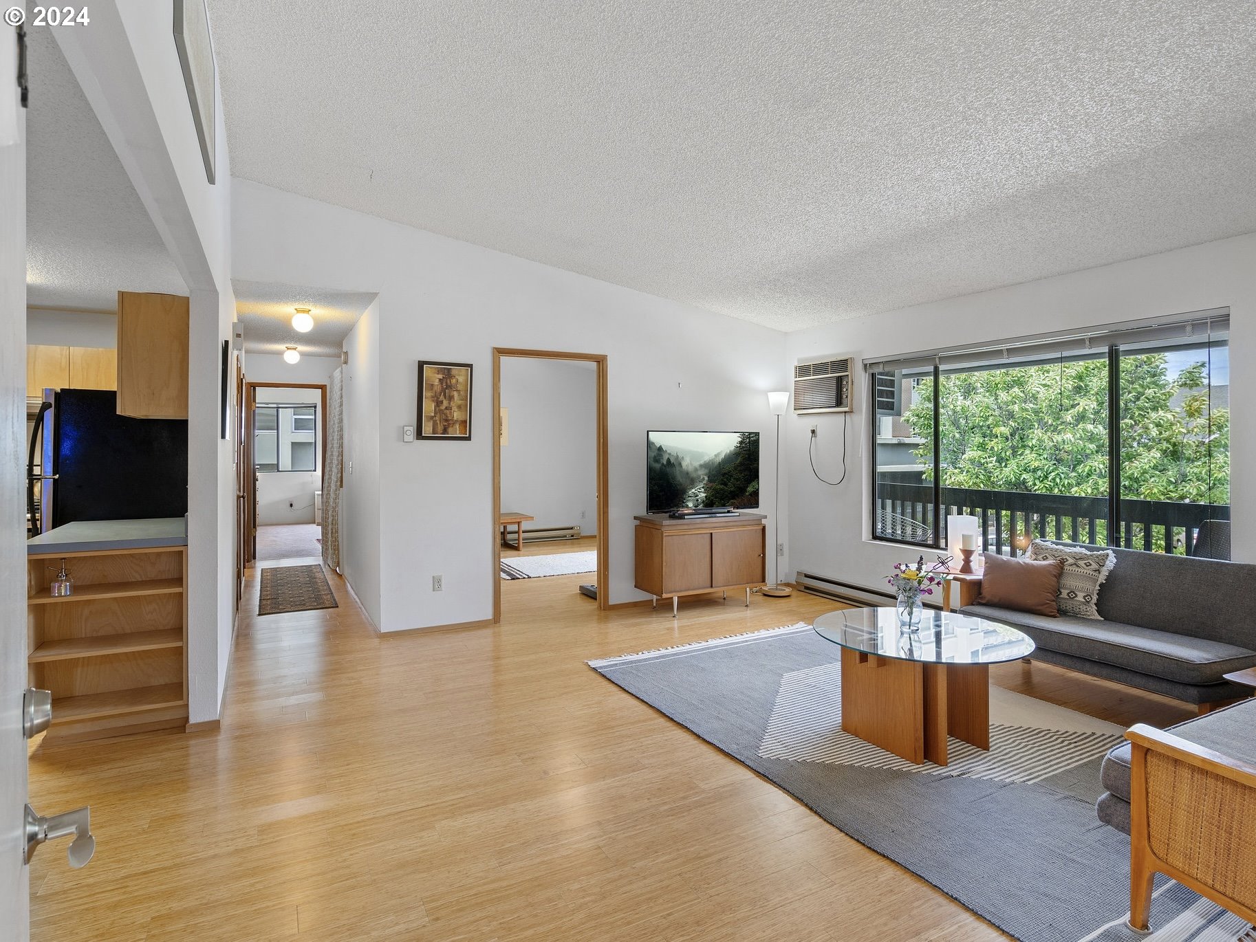 1727 Northeast Multnomah Street, Unit 14 Portland, OR 97232 - Photo 5 of 31 a living room with furniture large window and wooden floor