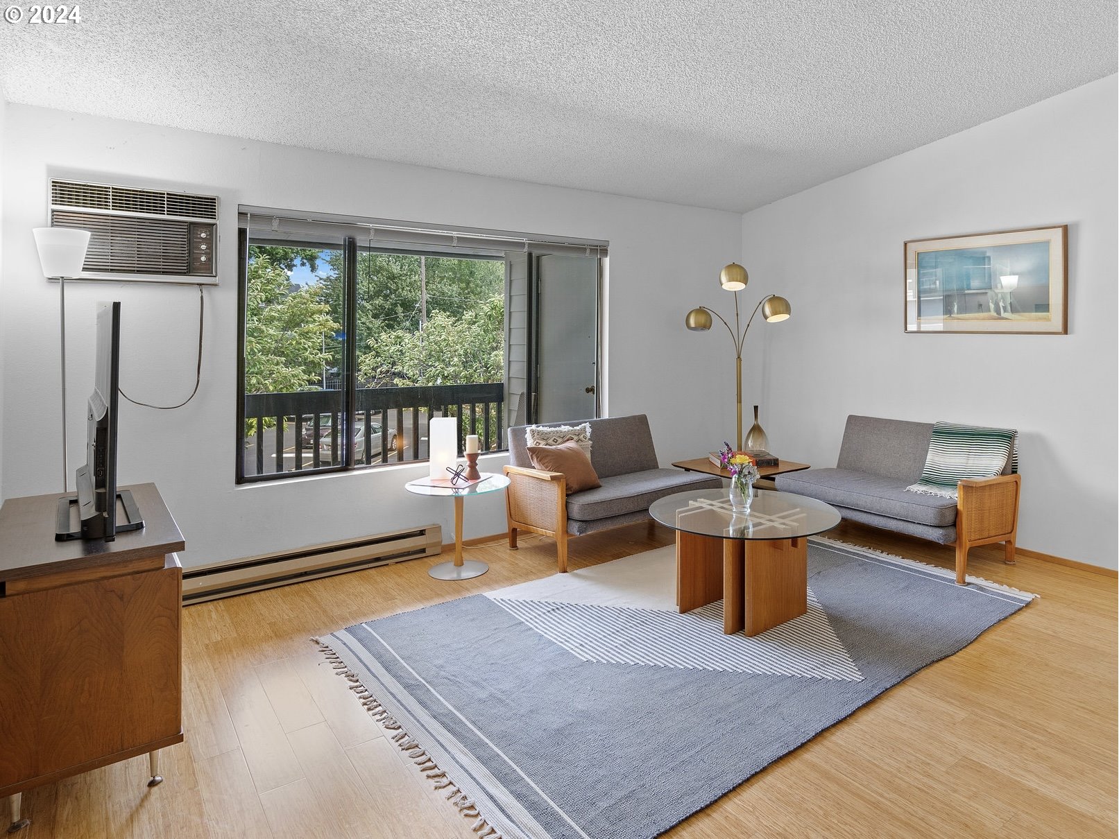 1727 Northeast Multnomah Street, Unit 14 Portland, OR 97232 - Photo 6 of 31 a living room with furniture a rug and a floor to ceiling window