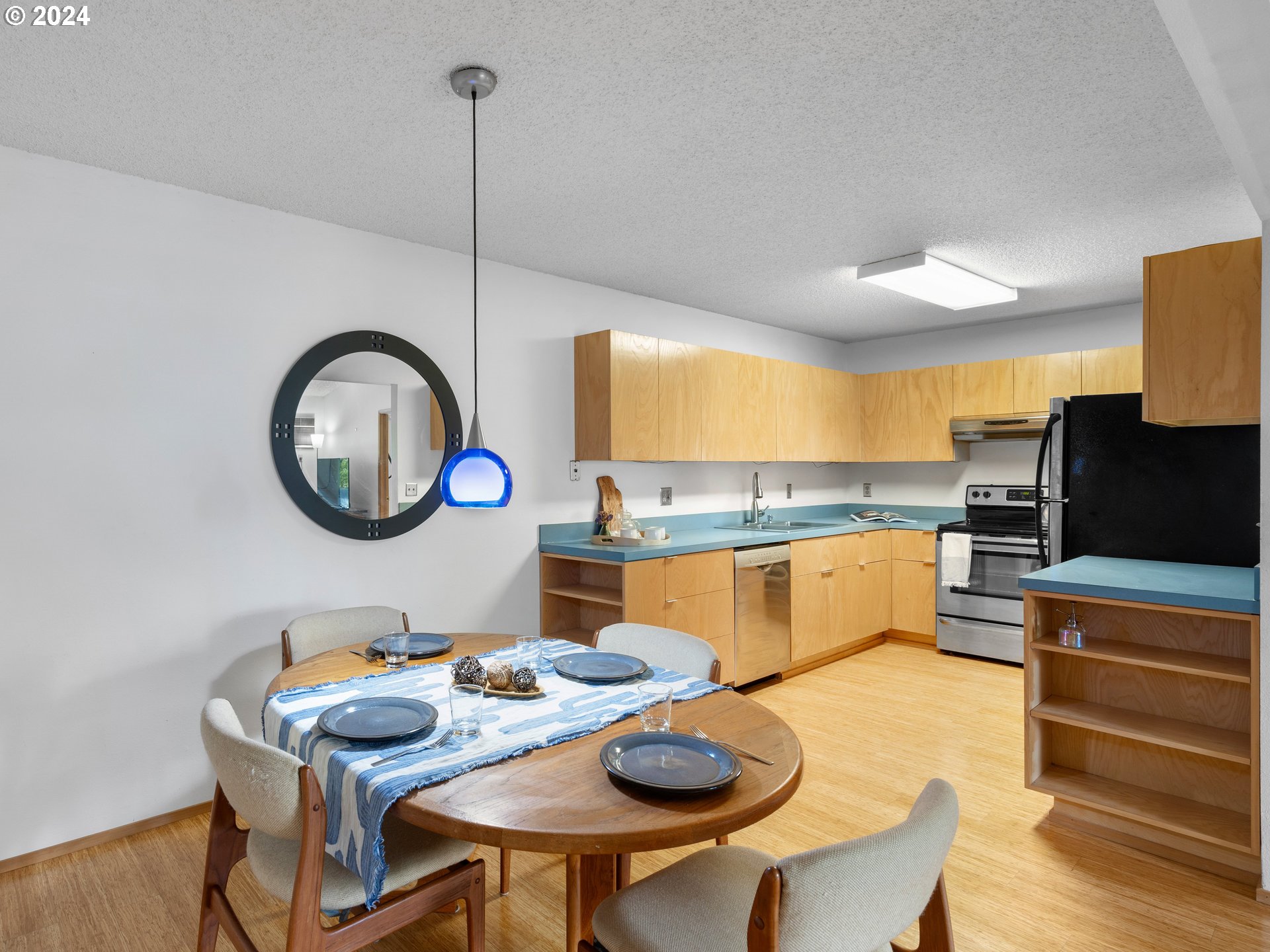 1727 Northeast Multnomah Street, Unit 14 Portland, OR 97232 - Photo 9 of 31 a kitchen with a table and chairs in it