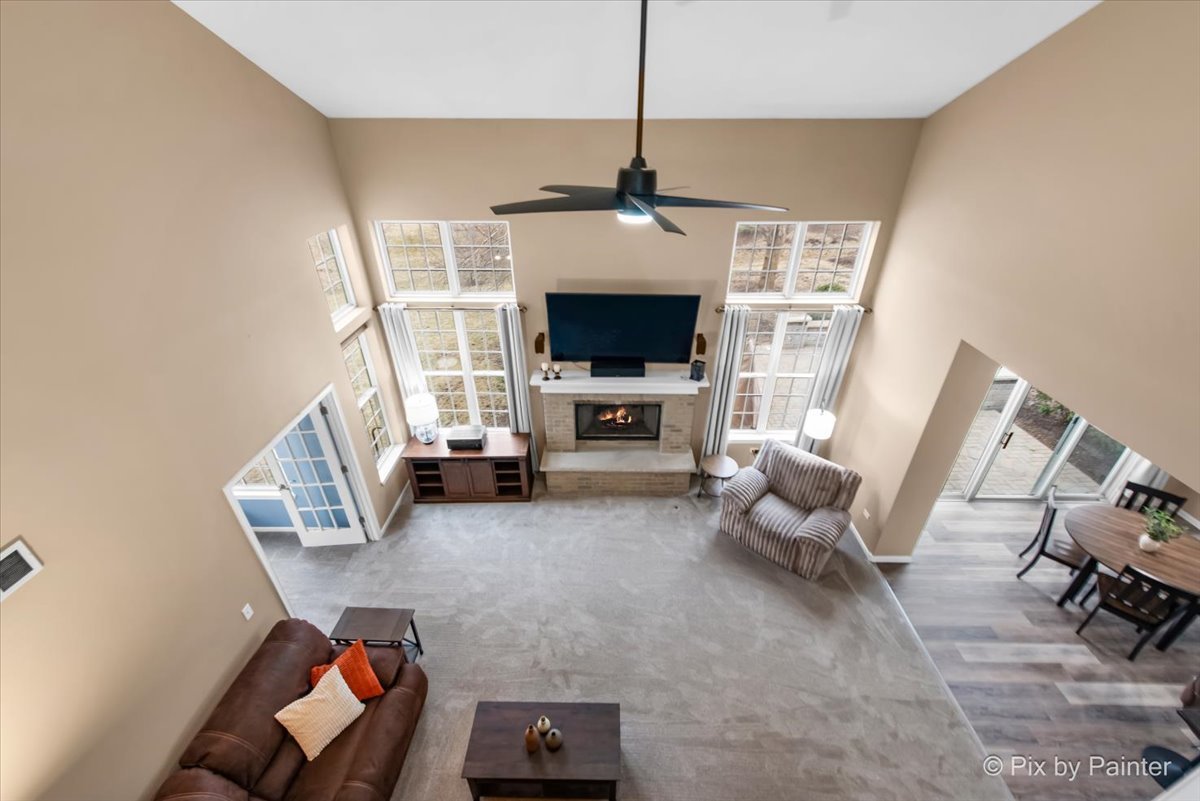 26428 Rustling Birch Way Plainfield, IL 60585 - Photo 14 of 49 a living room with furniture a fireplace and a flat screen tv