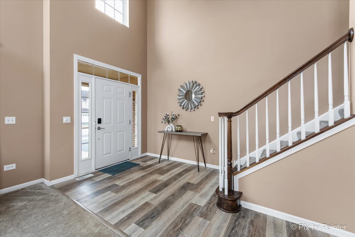 26428 Rustling Birch Way Plainfield, IL 60585 - Photo 17 of 49 a view of a hallway with wooden floor and staircase
