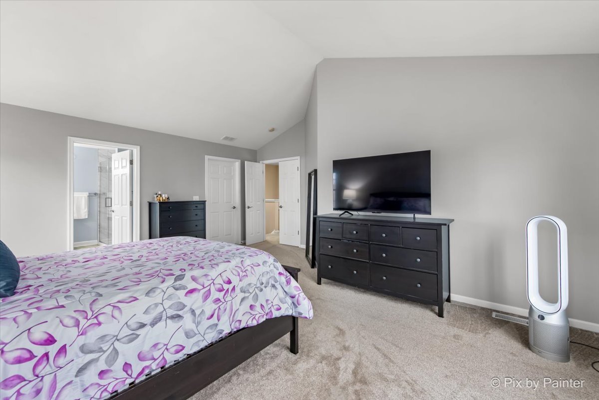 26428 Rustling Birch Way Plainfield, IL 60585 - Photo 20 of 49 a bedroom with a bed and a flat screen tv