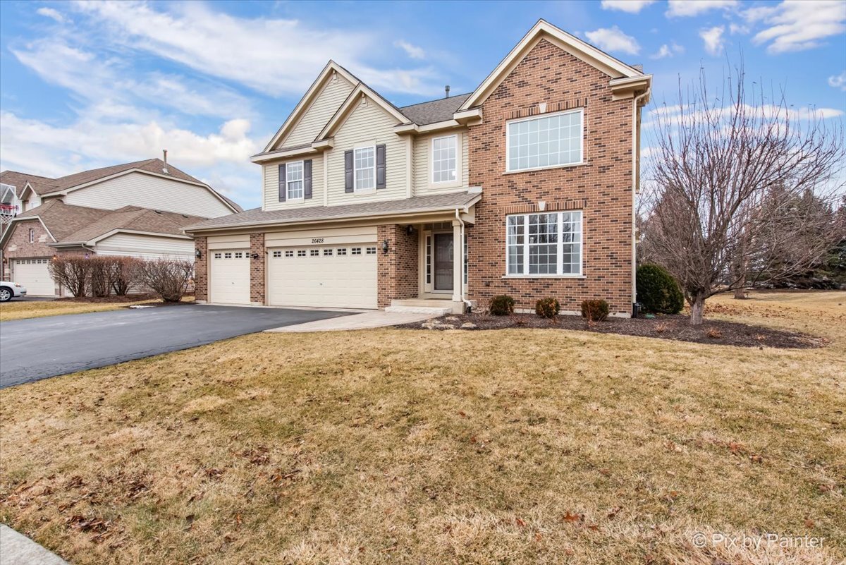 26428 Rustling Birch Way Plainfield, IL 60585 - Photo 2 of 49 a front view of a house with a yard and garage