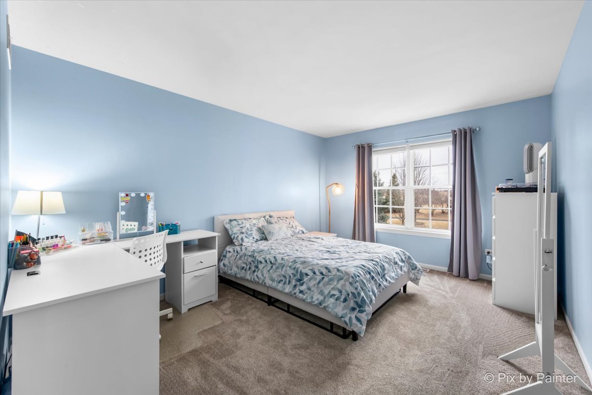 26428 Rustling Birch Way Plainfield, IL 60585 - Photo 23 of 49 a bedroom with a bed and a large window