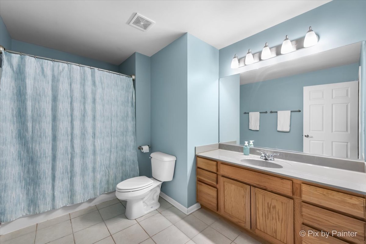 26428 Rustling Birch Way Plainfield, IL 60585 - Photo 24 of 49 a spacious bathroom with a toilet a sink and a mirror