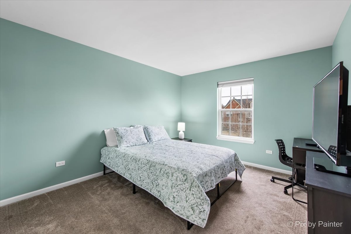 26428 Rustling Birch Way Plainfield, IL 60585 - Photo 26 of 49 a bedroom with a bed a table and a window