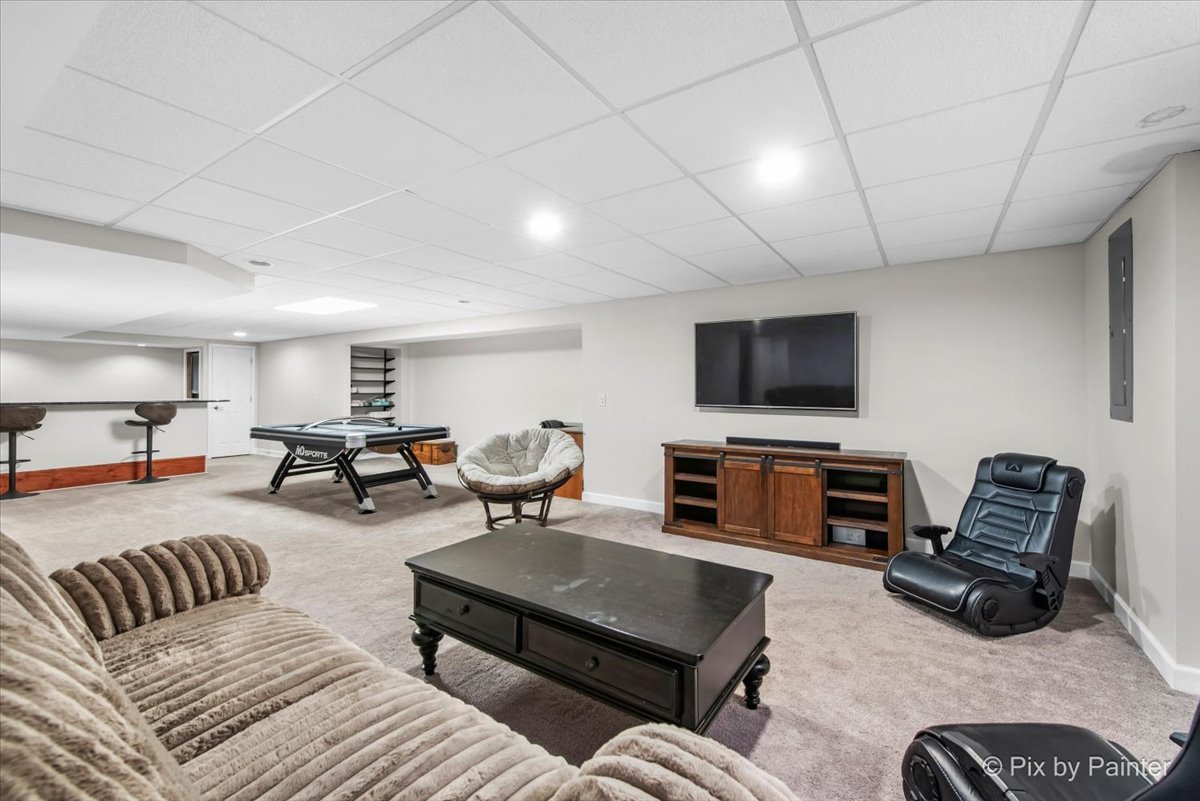 26428 Rustling Birch Way Plainfield, IL 60585 - Photo 28 of 49 a living room with furniture and a flat screen tv