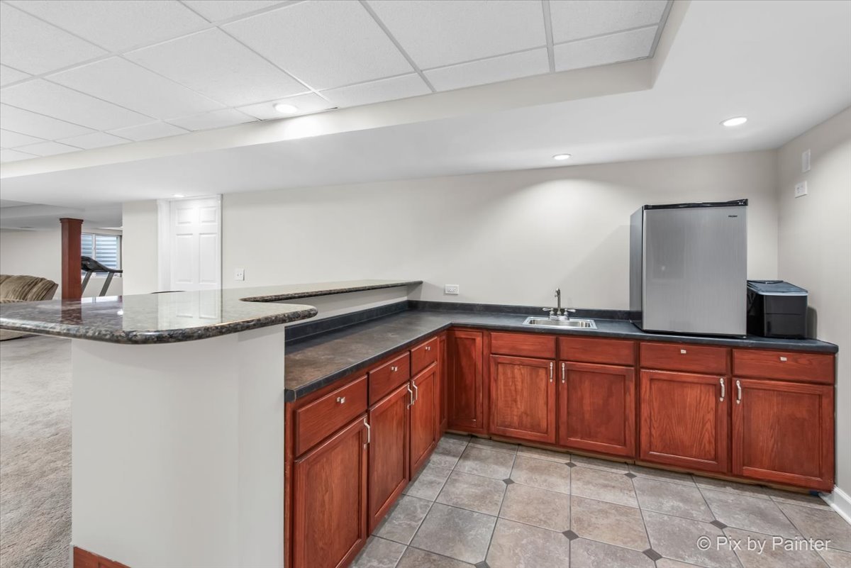 26428 Rustling Birch Way Plainfield, IL 60585 - Photo 30 of 49 a kitchen with stainless steel appliances granite countertop a sink and cabinets
