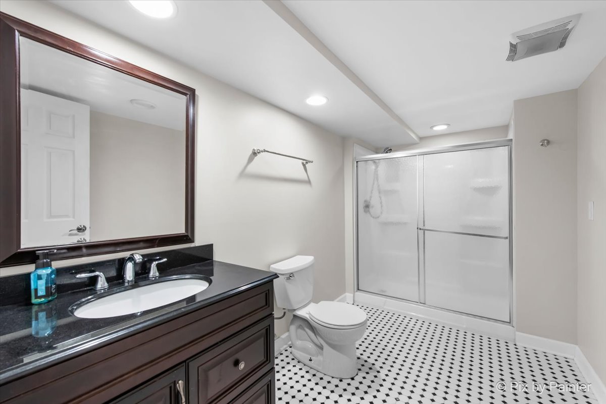 26428 Rustling Birch Way Plainfield, IL 60585 - Photo 33 of 49 a bathroom with a granite countertop sink a toilet a mirror and shower