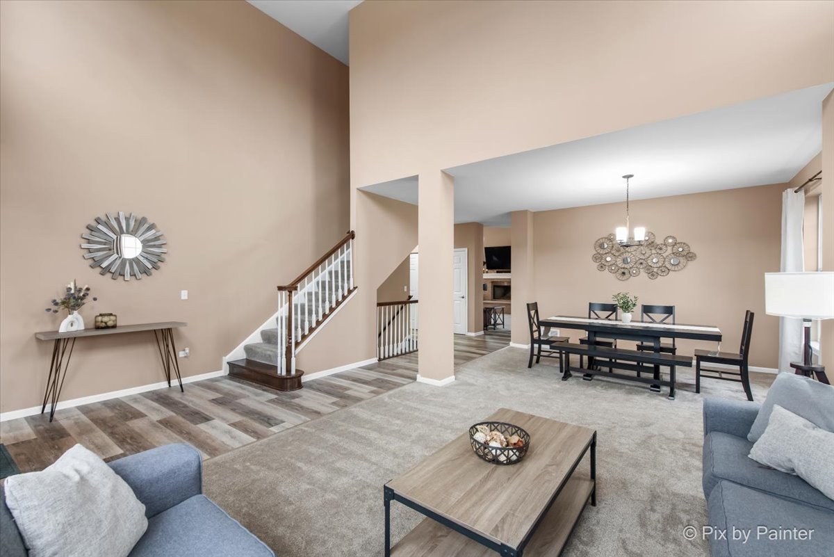 26428 Rustling Birch Way Plainfield, IL 60585 - Photo 9 of 49 a living room with furniture and a chandelier