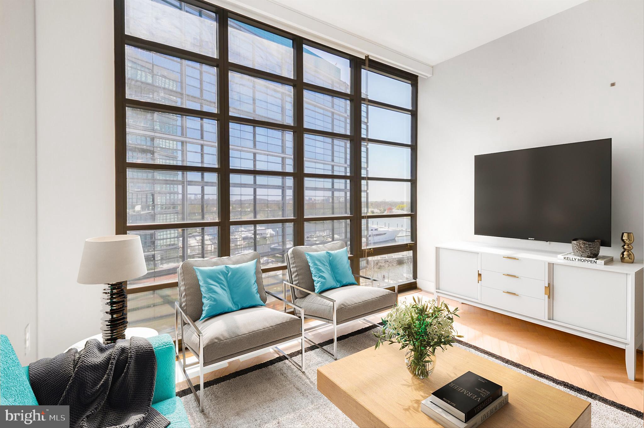 45 Sutton Square Southwest, Unit 607 Washington, DC 20024 - Photo 12 of 28 a living room with furniture and a flat screen tv