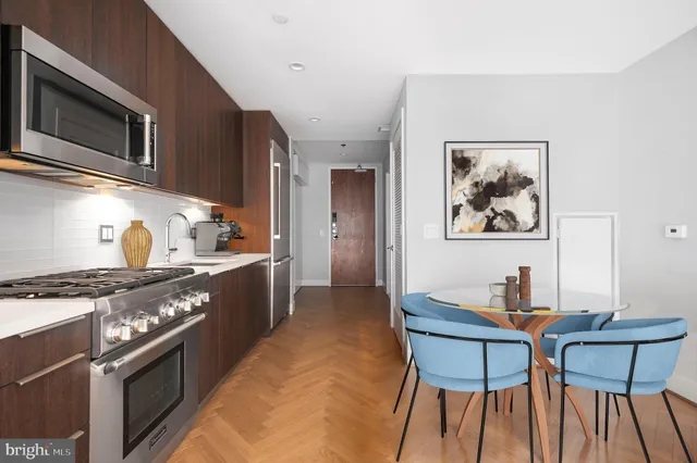a kitchen with stainless steel appliances a stove a sink dishwasher and cabinets