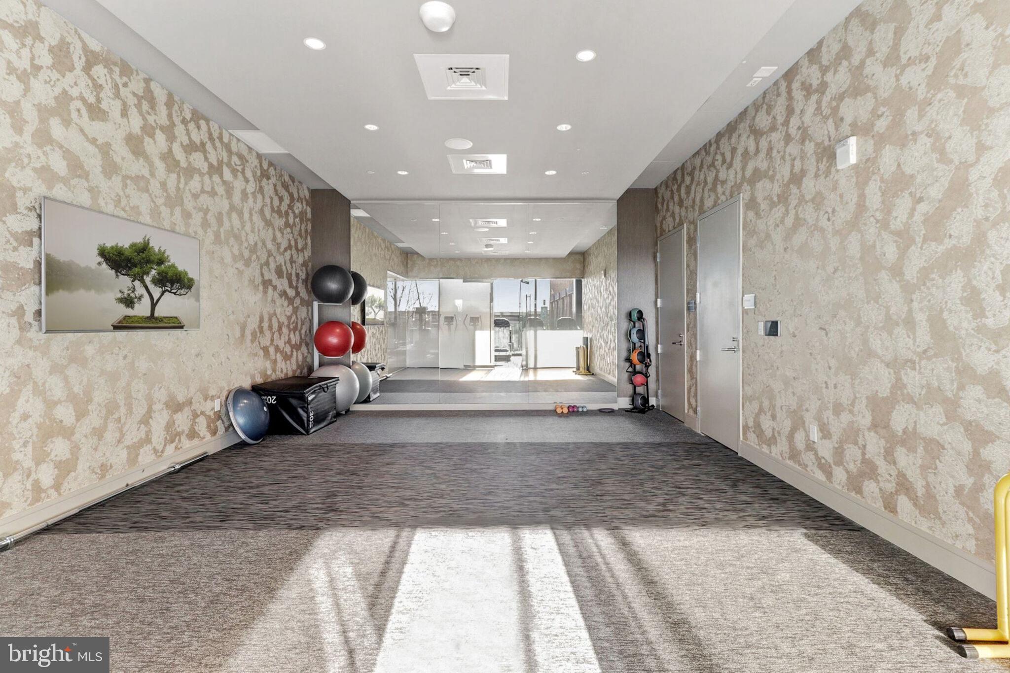45 Sutton Square Southwest, Unit 607 Washington, DC 20024 - Photo 20 of 28 a view of a hallway with a couch and a window