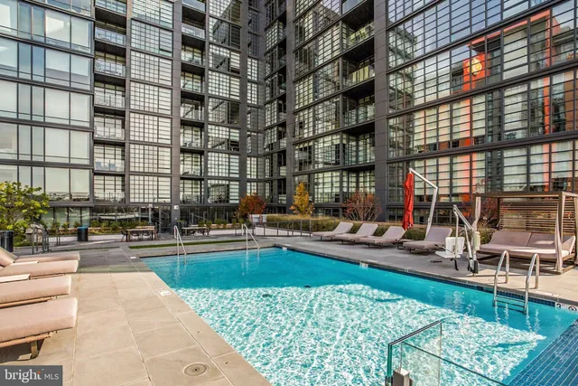 a view of swimming pool with outdoor seating and city view