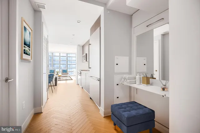 a bathroom with a sink a tub and a large mirror