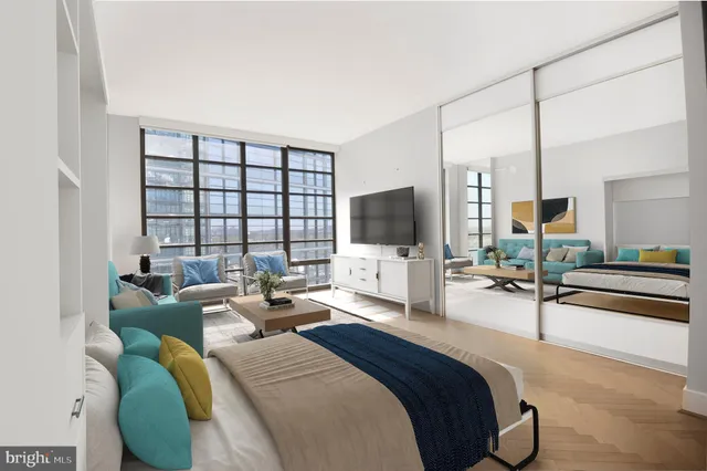 a bedroom with two beds and a flat screen tv