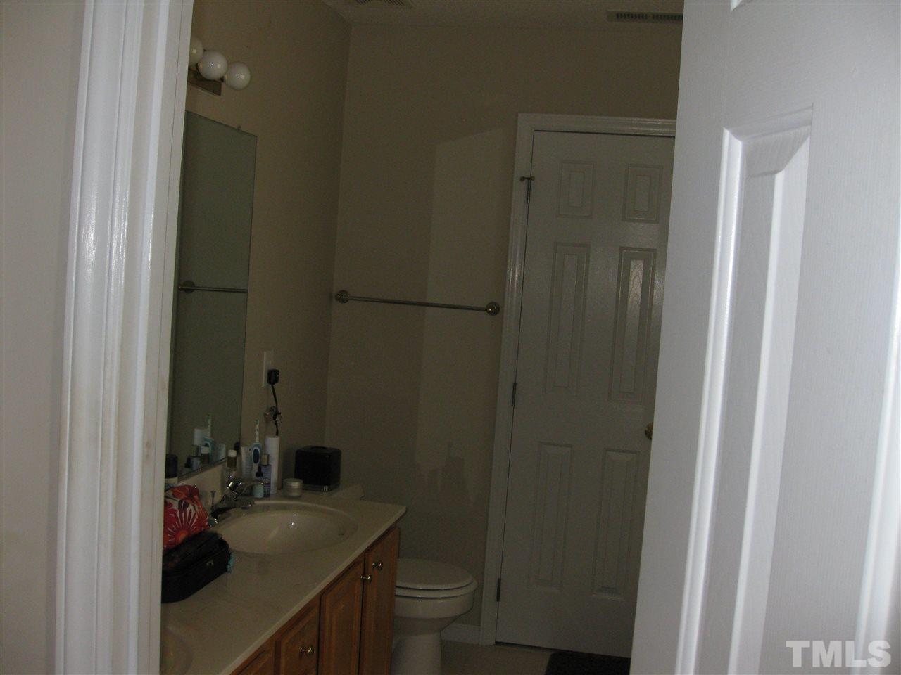 3313 Stone Castle Court Raleigh, NC 27613 - Photo 11 of 15 a bathroom with a sink a toilet and shower curtain