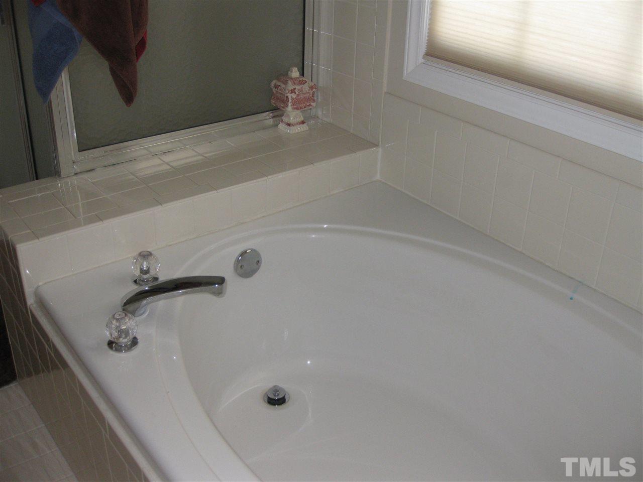 3313 Stone Castle Court Raleigh, NC 27613 - Photo 12 of 15 a bathroom with a tub