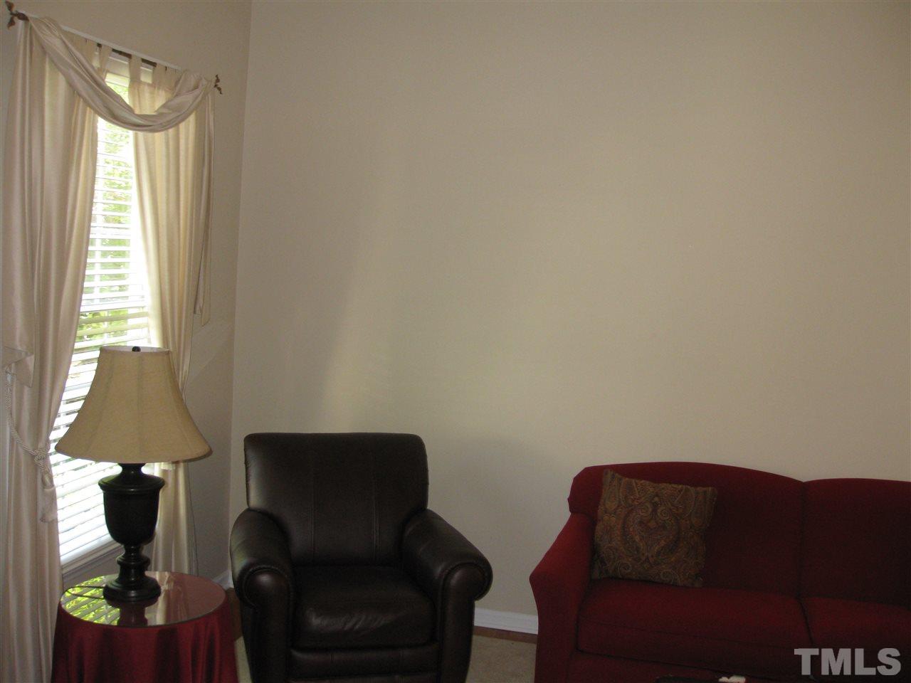 3313 Stone Castle Court Raleigh, NC 27613 - Photo 3 of 15 a living room with furniture and a lamp
