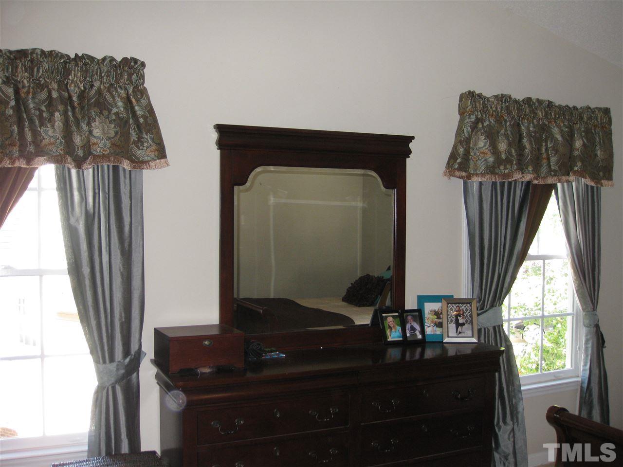 3313 Stone Castle Court Raleigh, NC 27613 - Photo 10 of 15 a bathroom with a sink a mirror and window