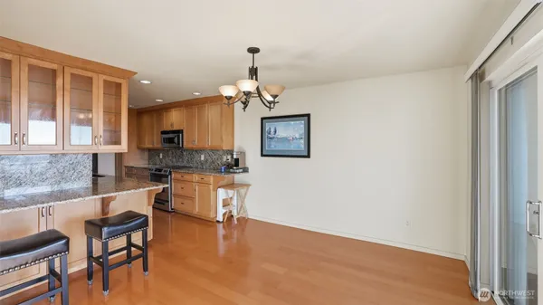 a kitchen with granite countertop a sink a stove and cabinets