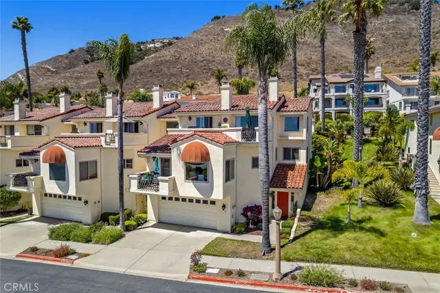 a front view of a multi story residential apartment building with yard
