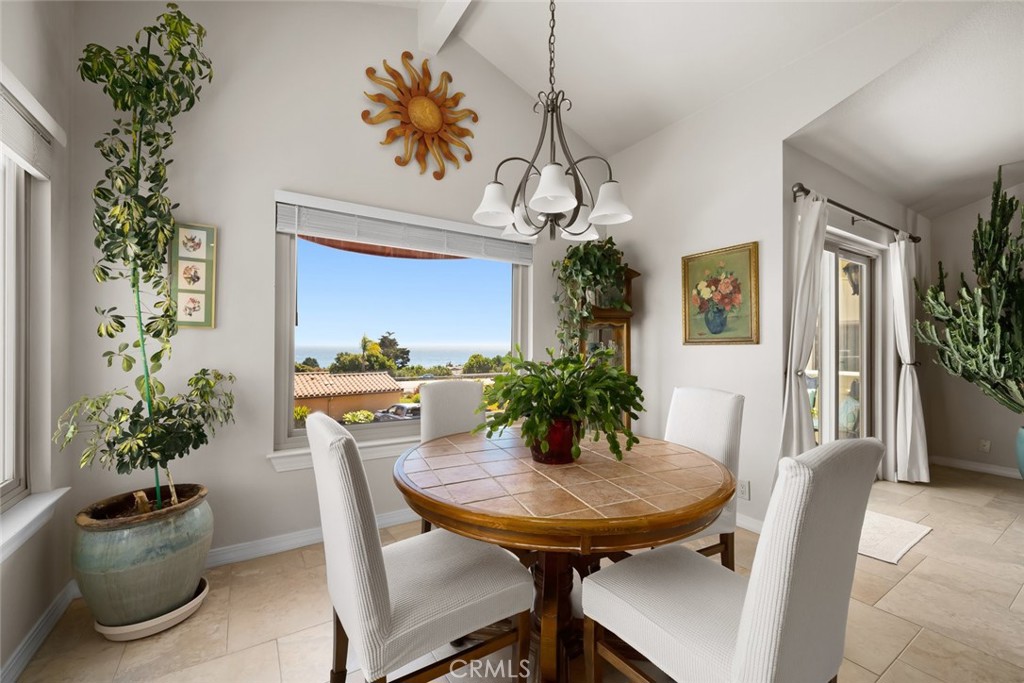 2100 Costa Del Sol Pismo Beach, CA 93449 - Photo 12 of 27 a view of a dining room with furniture and chandelier