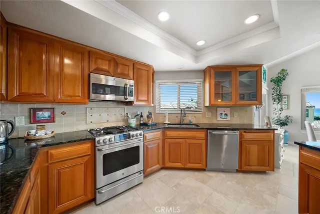 a kitchen with stainless steel appliances a refrigerator sink and cabinets