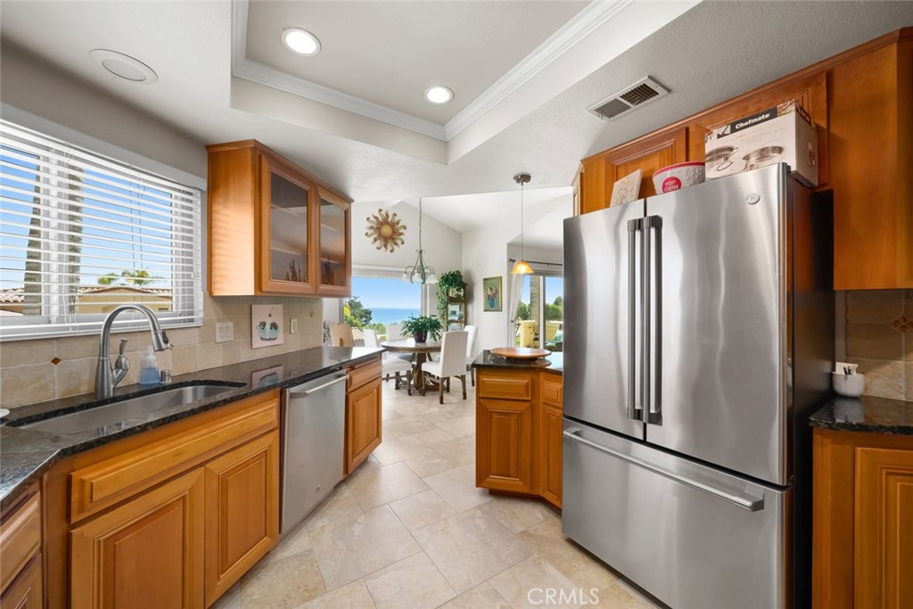 2100 Costa Del Sol Pismo Beach, CA 93449 - Photo 15 of 27 a kitchen with stainless steel appliances granite countertop a refrigerator and a sink