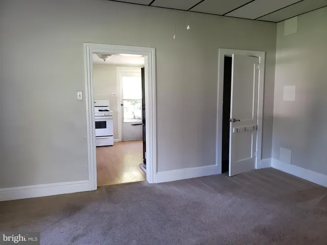 an empty room with closet and a bathroom