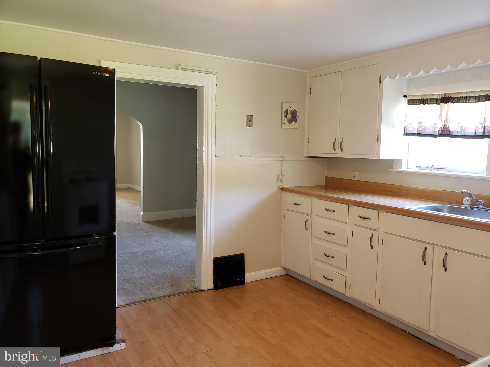 625 North Forklanding Road Maple Shade, NJ 08052 - Photo 7 of 16 a kitchen with granite countertop white cabinets and refrigerator