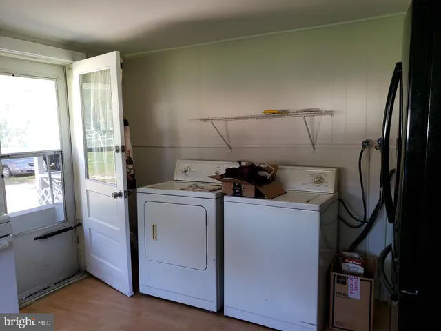 a view of a storage and utility room with washer and dryer