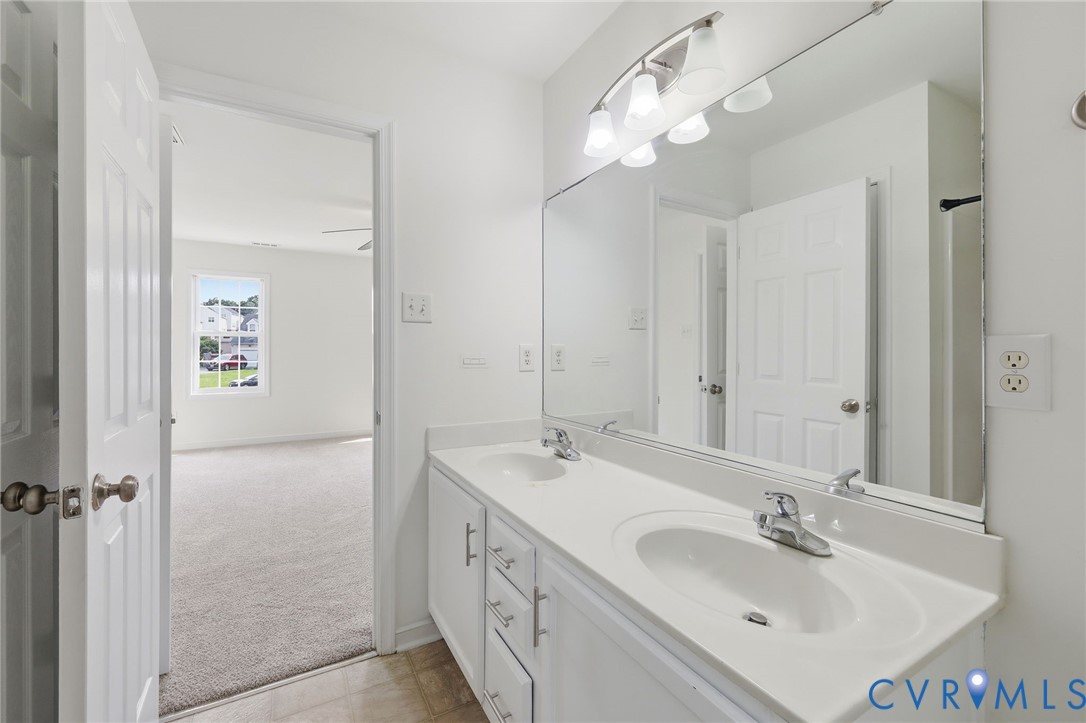 7610 Sugar Run Road Hopewell, VA 23860 - Photo 16 of 48 Bathroom vanity featuring dual undermount sinks, a