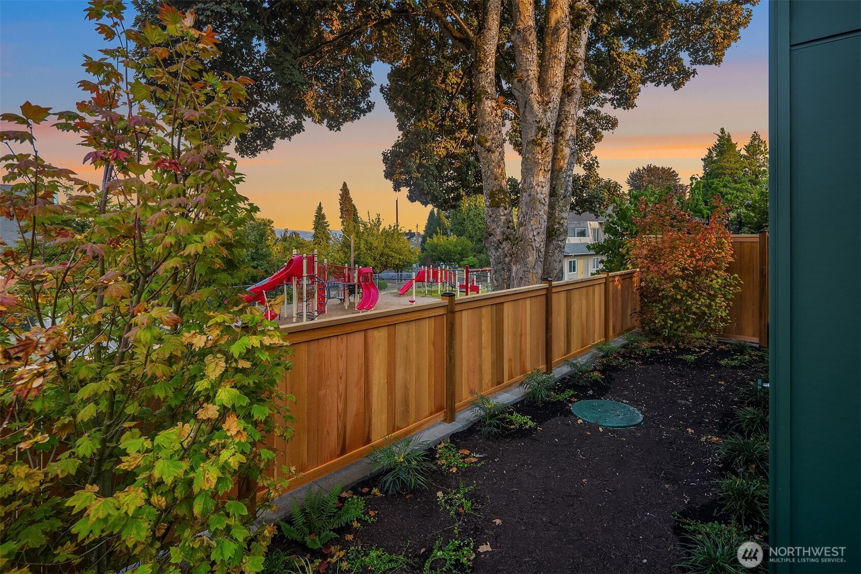 920 34th Avenue, Unit B Seattle, WA 98122 - Photo 5 of 38 a wooden fence with trees in the background