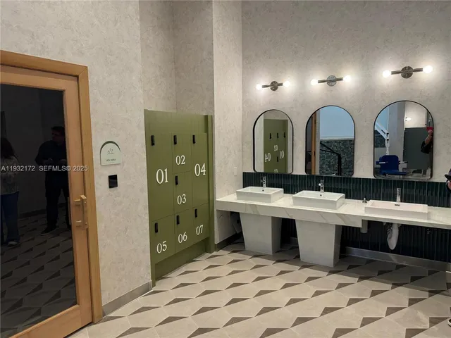 a view of a bathroom with dual sinks