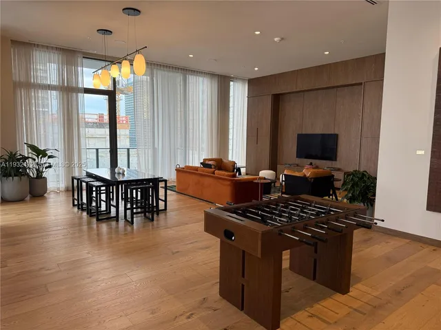 a dining room with furniture window and wooden floor
