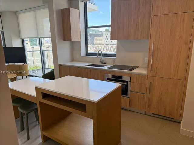 a kitchen with a stove a sink and a refrigerator