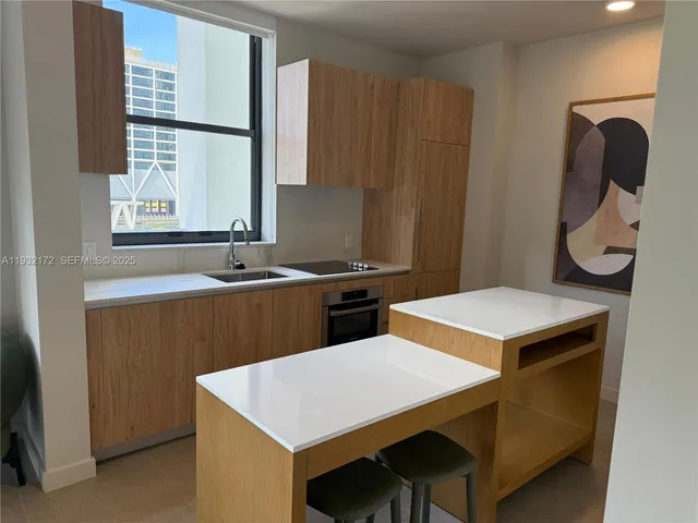 a kitchen that has a sink and a stove in it