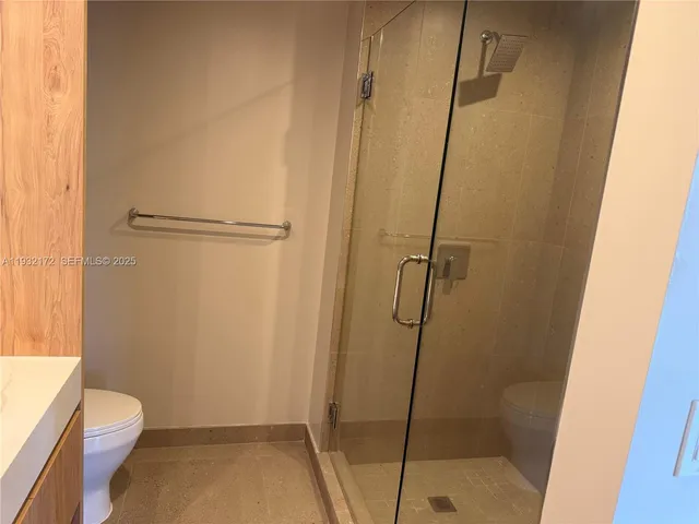 a bathroom with a toilet and shower