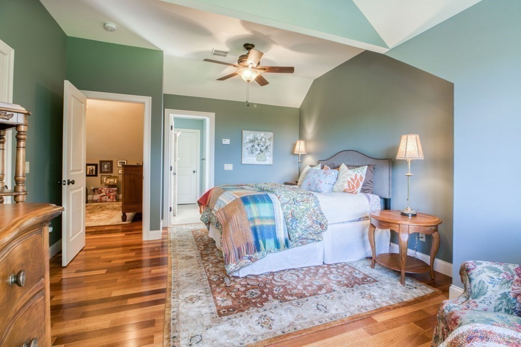 791 Ridge Road Wilbraham, MA 01095 - Photo 26 of 40 a bedroom with a large bed and a chandelier
