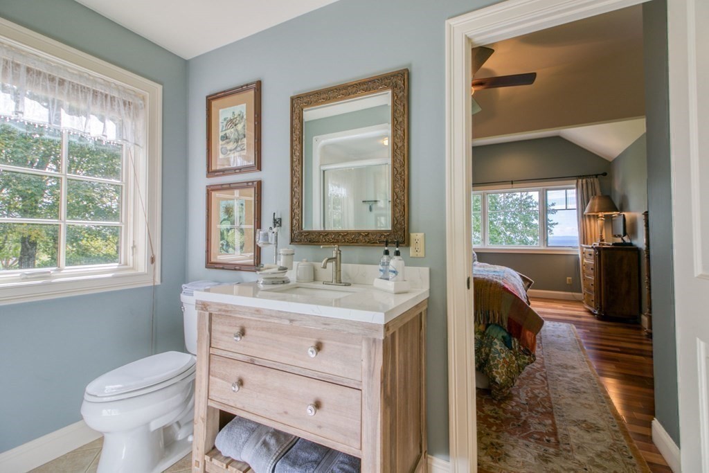 791 Ridge Road Wilbraham, MA 01095 - Photo 27 of 40 a bathroom with a sink a toilet and a mirror