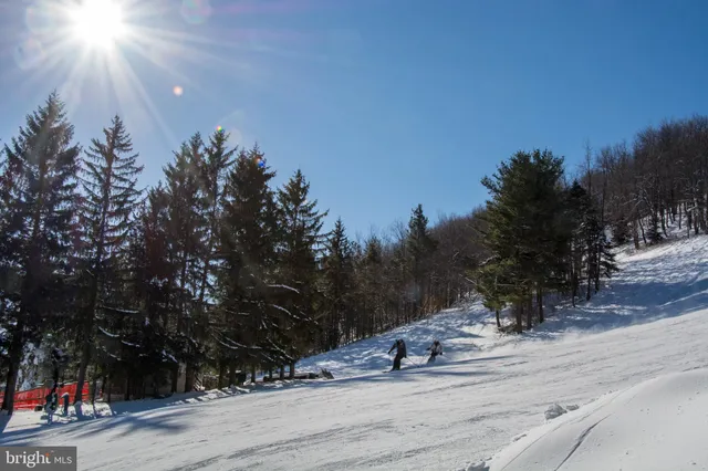 a view of swimming pool with a yard and outdoor seating