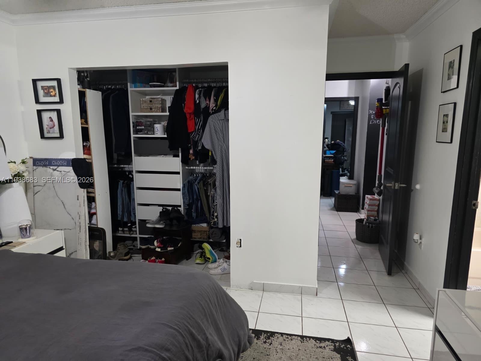 4837 Southwest 144th Court Miami, FL 33175 - Photo 8 of 10 a view of walk in closet with clothes and shoes