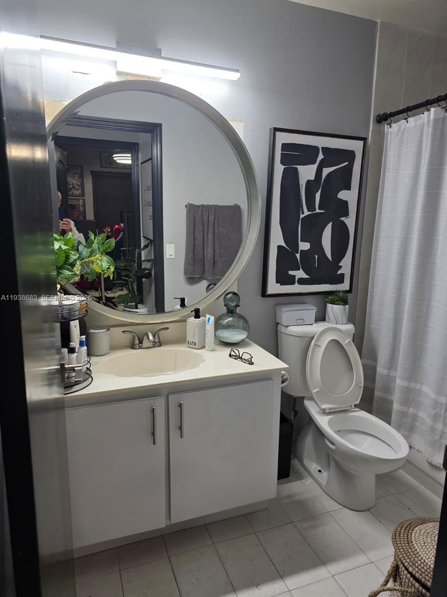 4837 Southwest 144th Court Miami, FL 33175 - Photo 9 of 10 a bathroom with a toilet sink and mirror