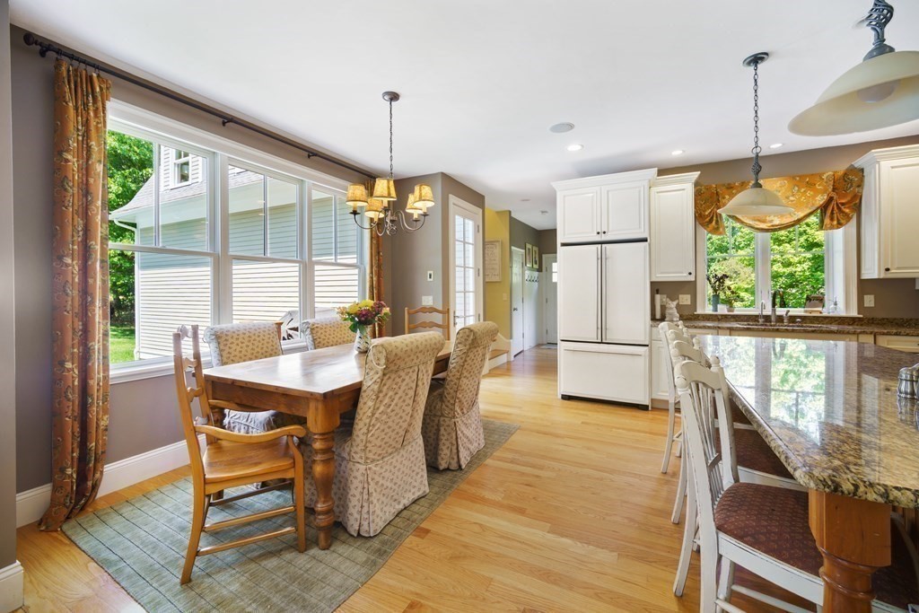 19 Marked Tree Road Sudbury, MA 01776 - Photo 16 of 42 a dining room with furniture a chandelier and wooden floor