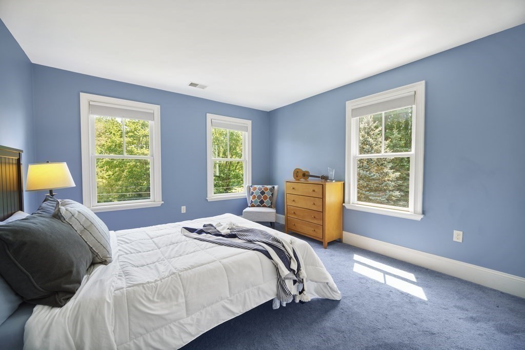 19 Marked Tree Road Sudbury, MA 01776 - Photo 22 of 42 a bed sitting in a bedroom next to a window