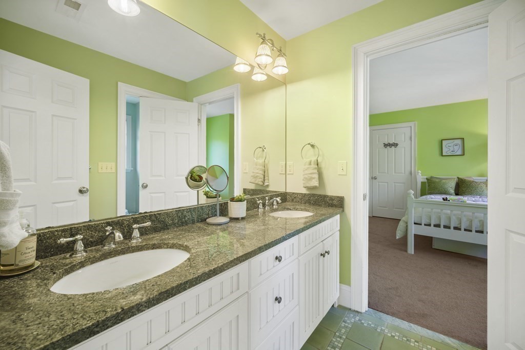 19 Marked Tree Road Sudbury, MA 01776 - Photo 26 of 42 a bathroom with a granite countertop sink and a mirror