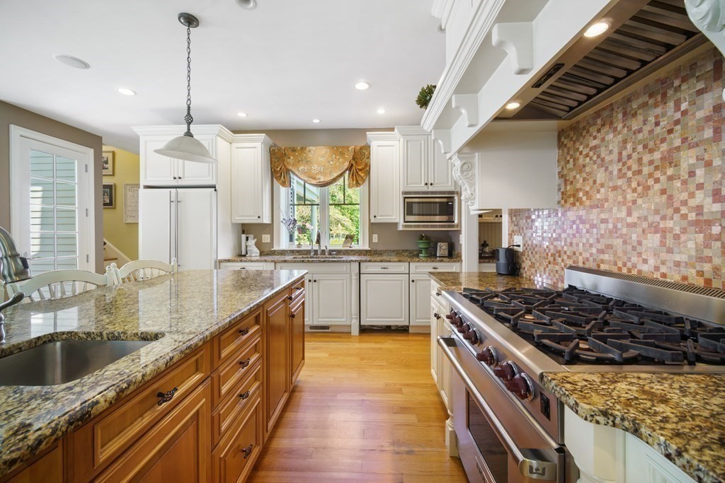 19 Marked Tree Road Sudbury, MA 01776 - Photo 6 of 42 a kitchen with stainless steel appliances granite countertop a sink stove and refrigerator