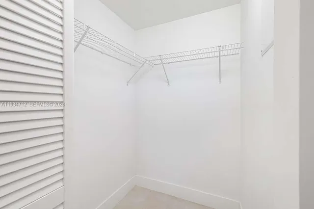 a view of a kitchen with a sink and a cabinet