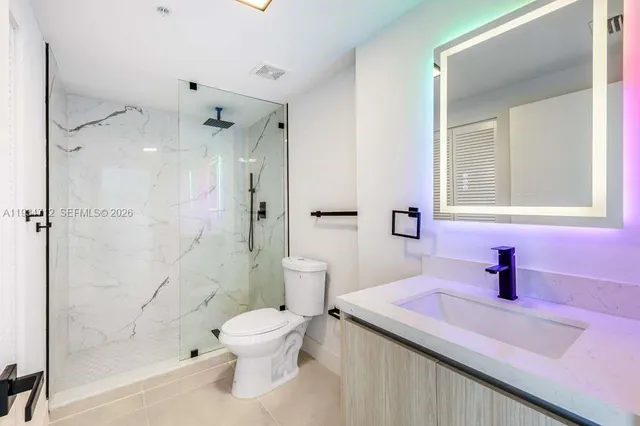 a kitchen with a stove a refrigerator and a sink